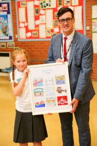 Sophie Harper, a year 5 pupil at Diamond Hall Juniors in Sunderland with her winning bridge-themed artwork, and Councillor Michael Mordey.